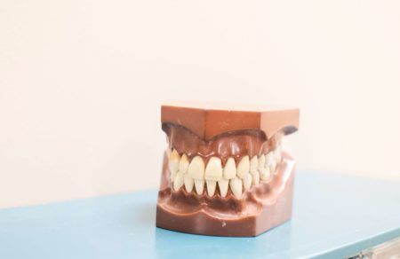 teeth denture on top of blue shelf
