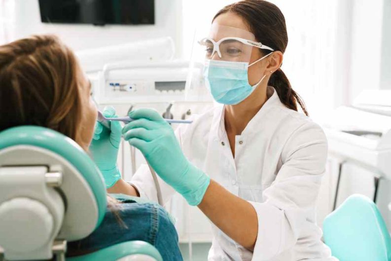 Dentist inspecting the oral health of a patient