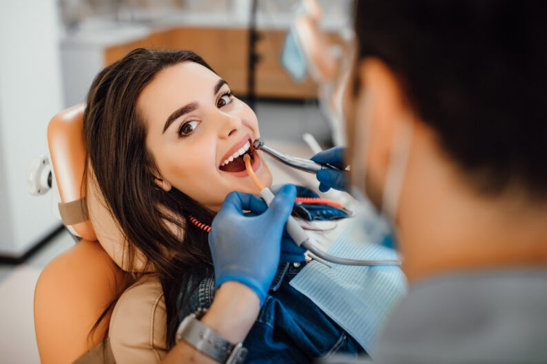 young woman getting a professional teeth cleaning